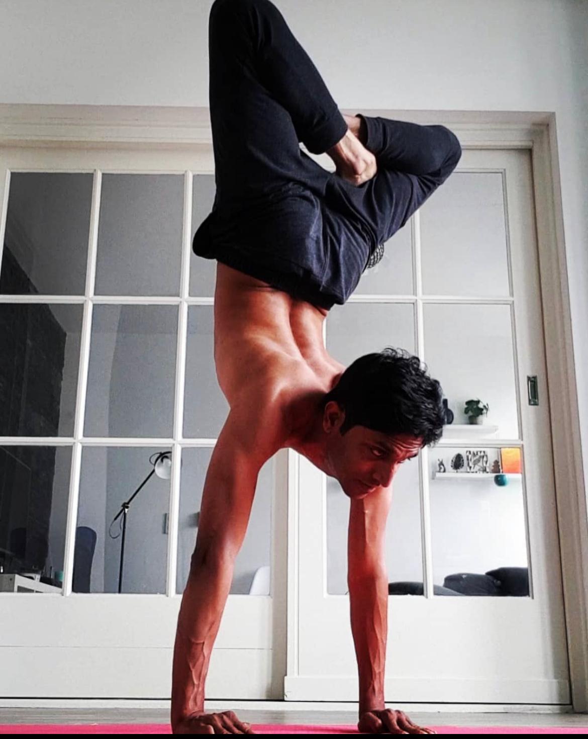 Farooq demonstrating a compact handstand variation during his personal yoga practice